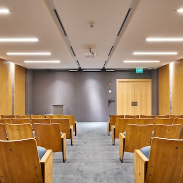 a room with chairs and a podium