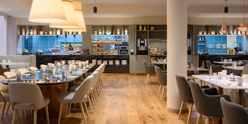 a restaurant with a large table and chairs