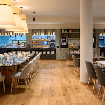 a restaurant with a large table and chairs