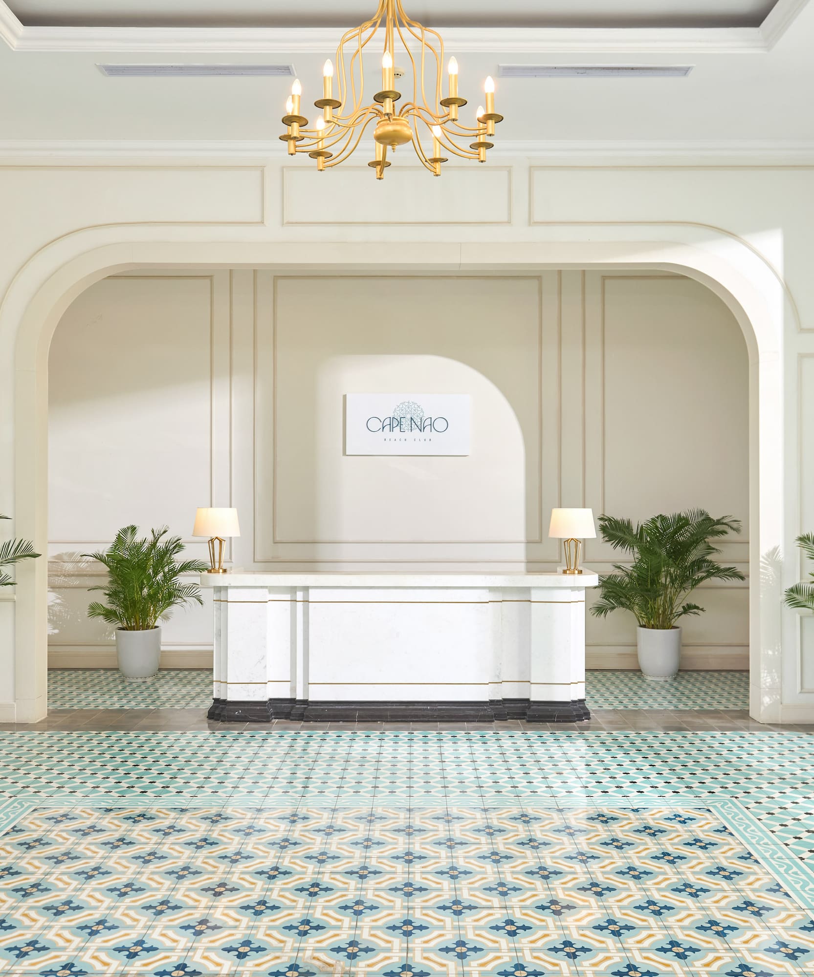 a white table with a white table and green plants in a room