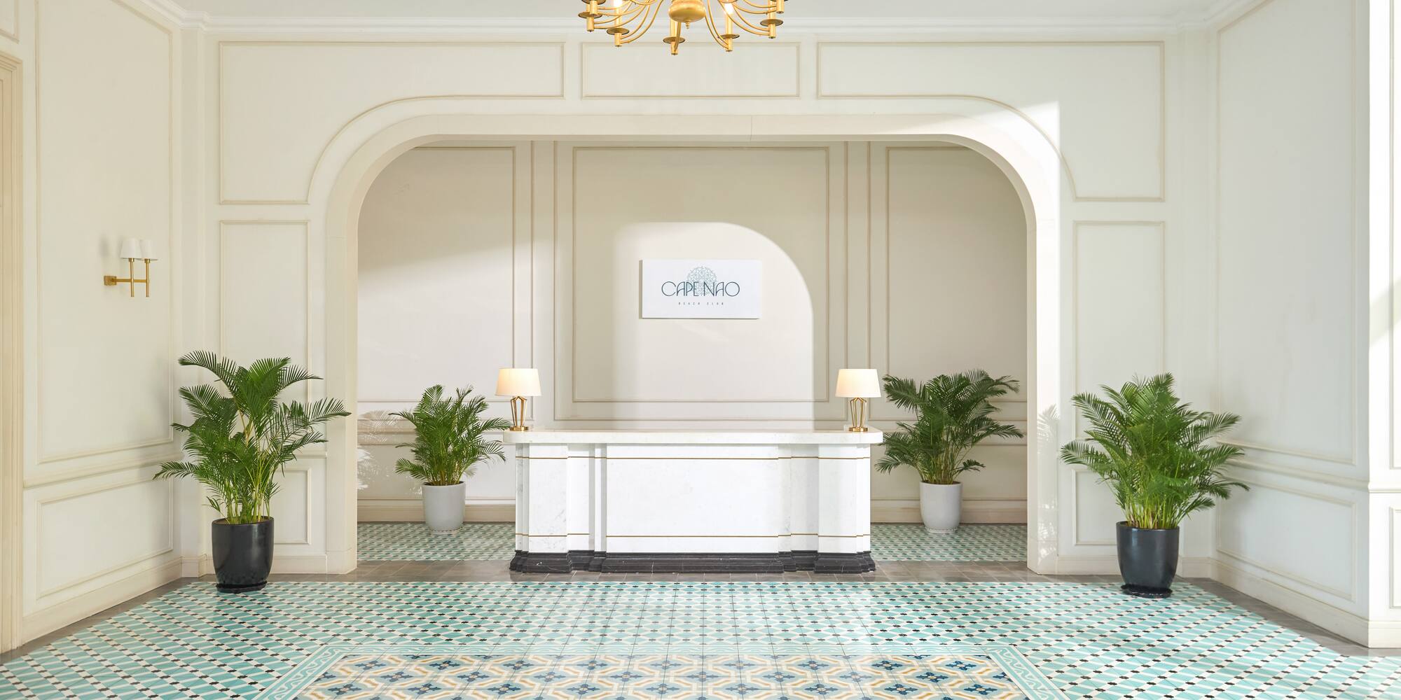 a white table with a white table and green plants in a room