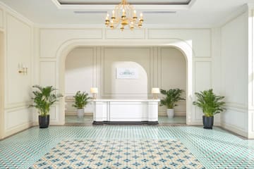 a white table with a white table and green plants in a room
