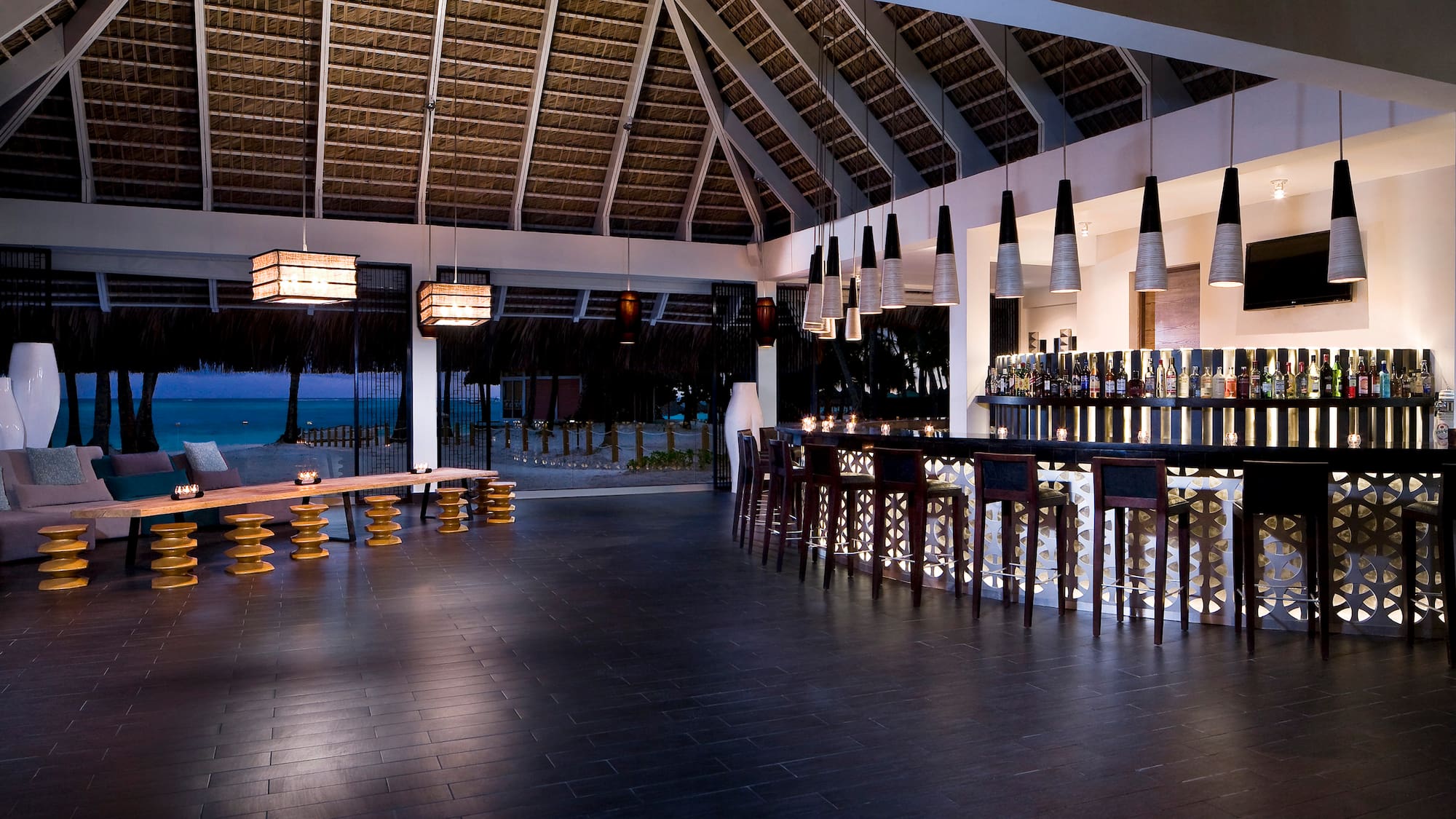 a bar with a long counter and a long bench