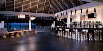 a bar with a long counter and a long bench