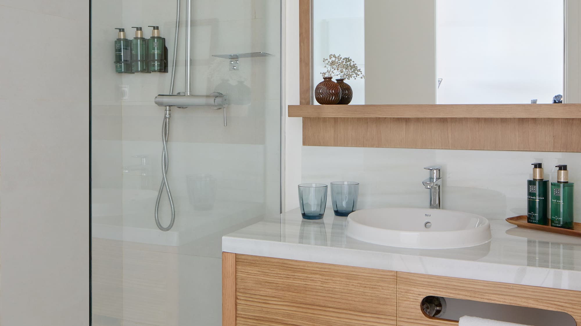 a bathroom with a glass shower and sink
