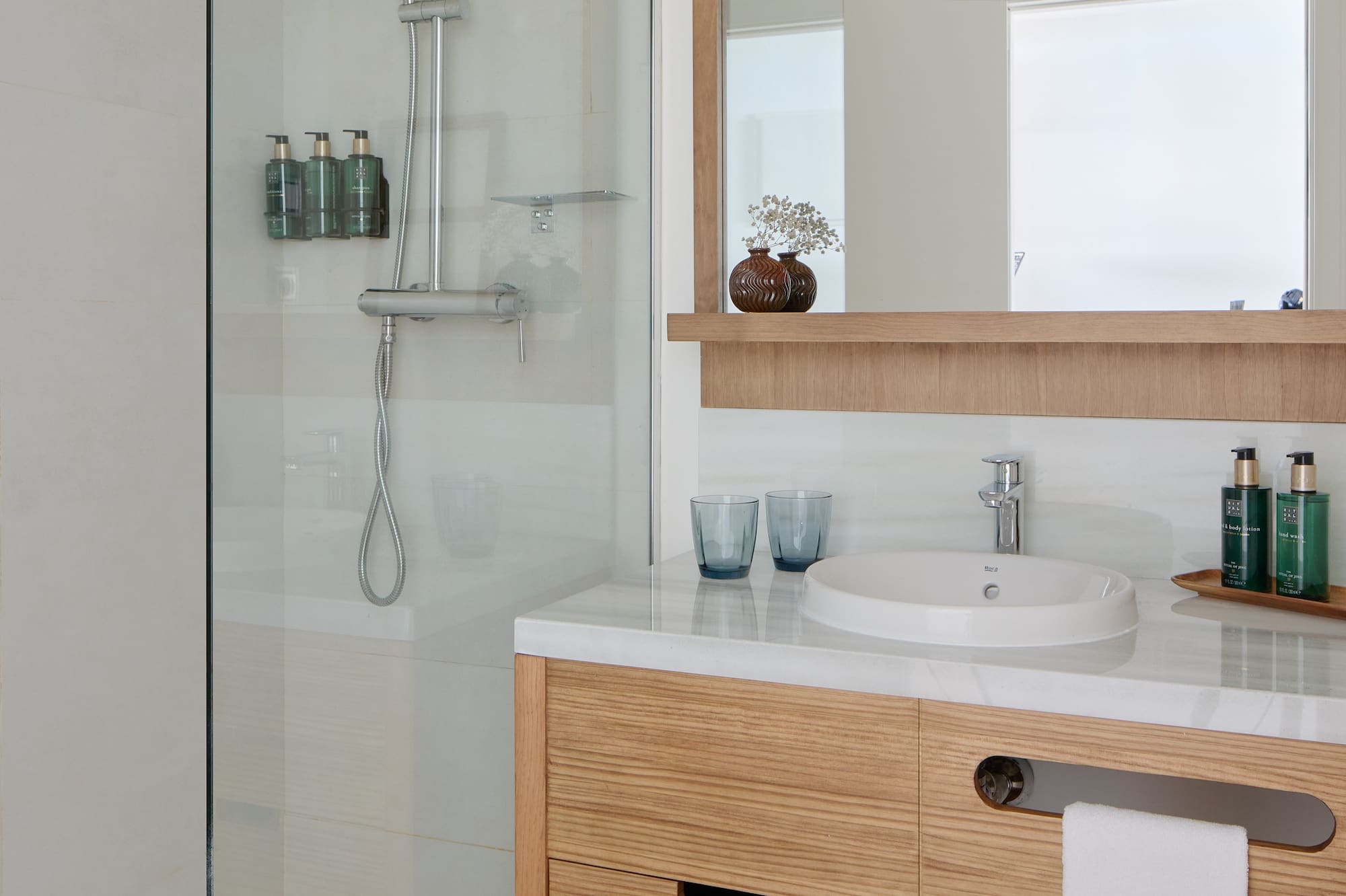 a bathroom with a glass shower and sink