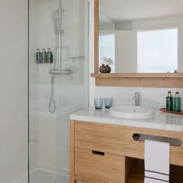 a bathroom with a glass shower and sink