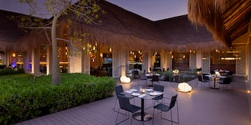 a restaurant with tables and chairs on a deck