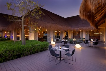 a restaurant with tables and chairs on a deck
