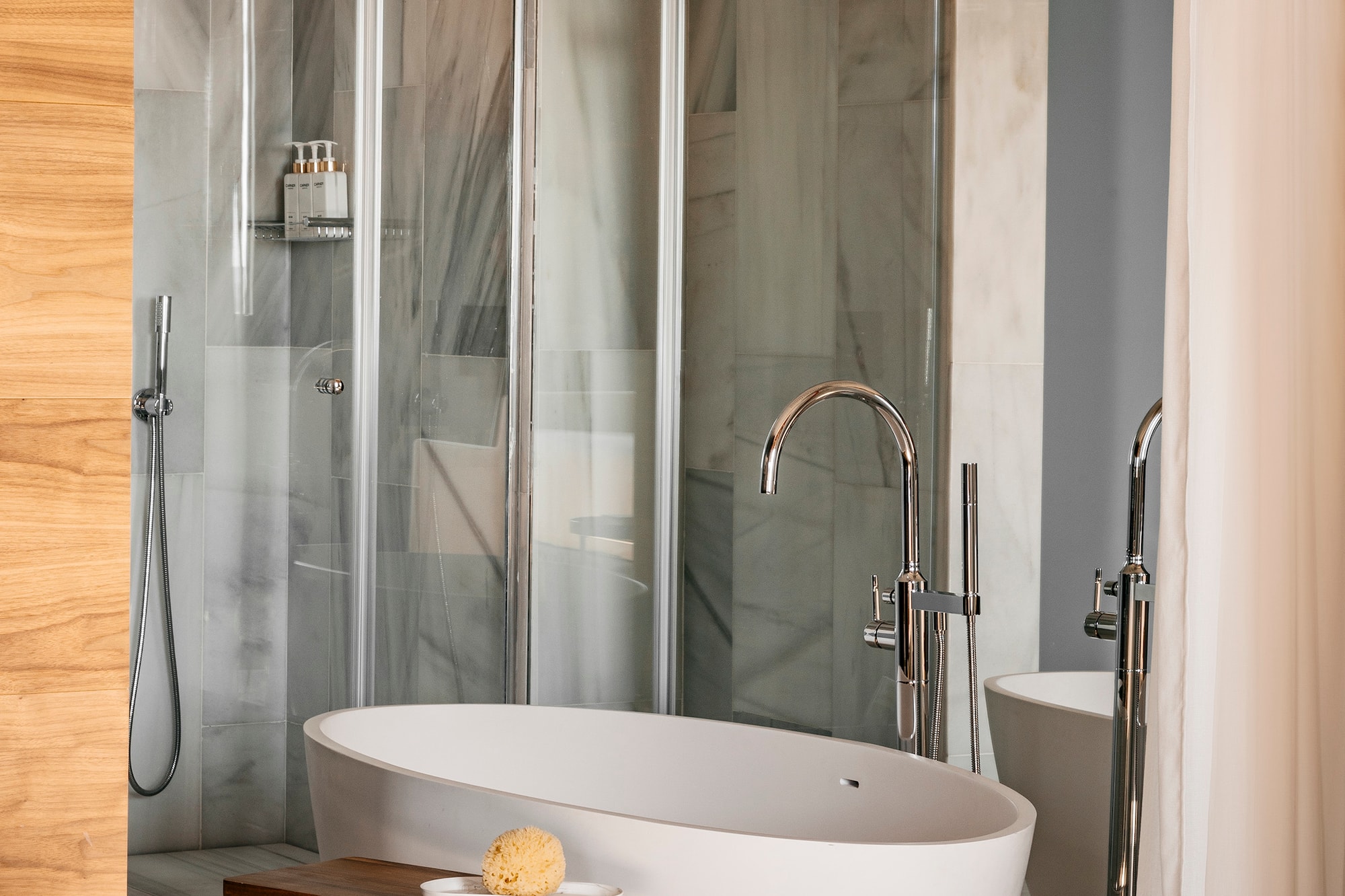 a bathroom with a tub and shower