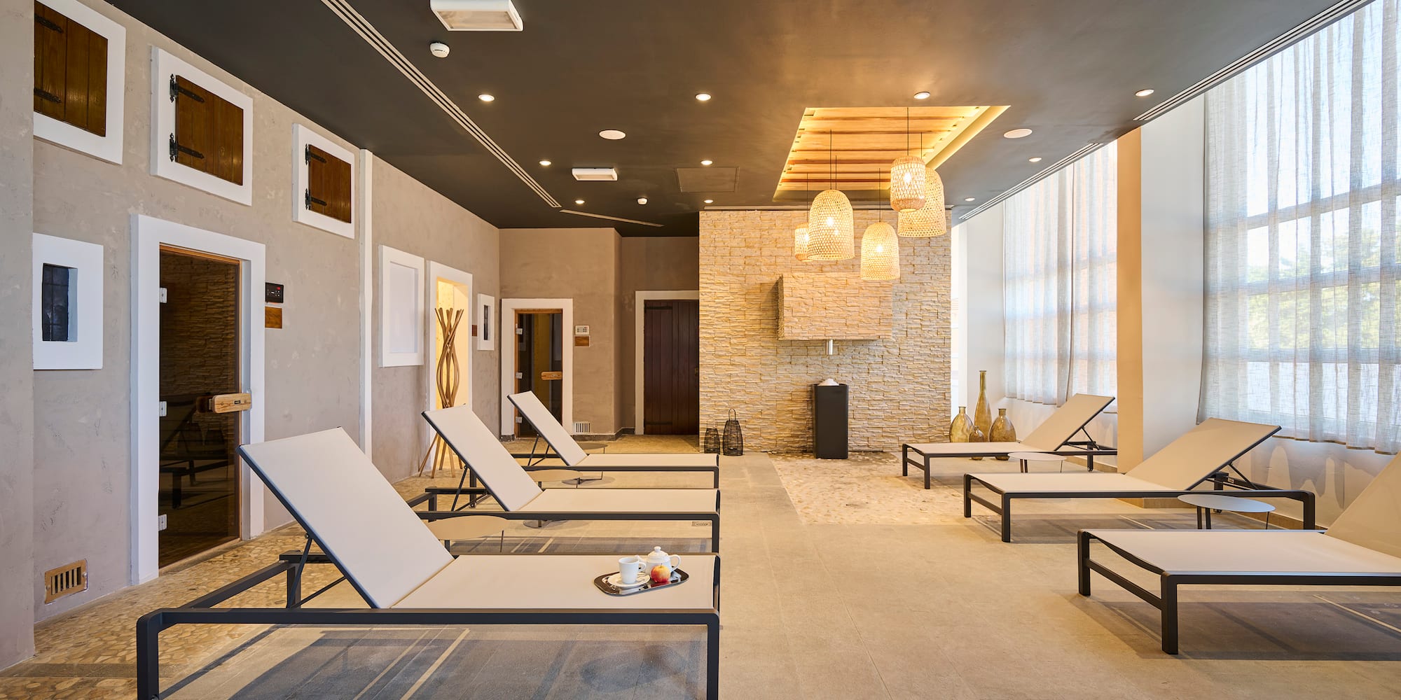 a room with lounge chairs and a fireplace