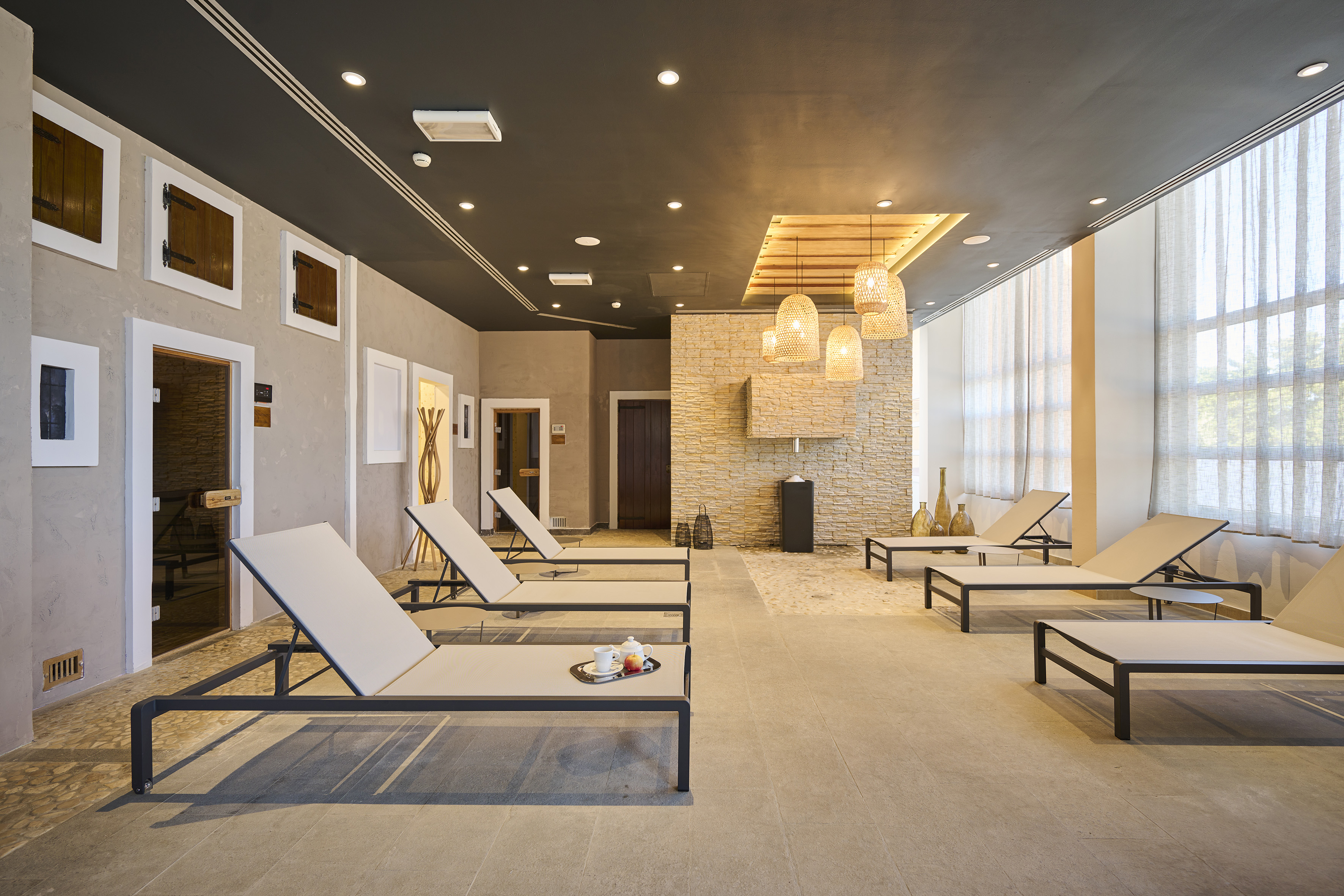 a room with lounge chairs and a fireplace