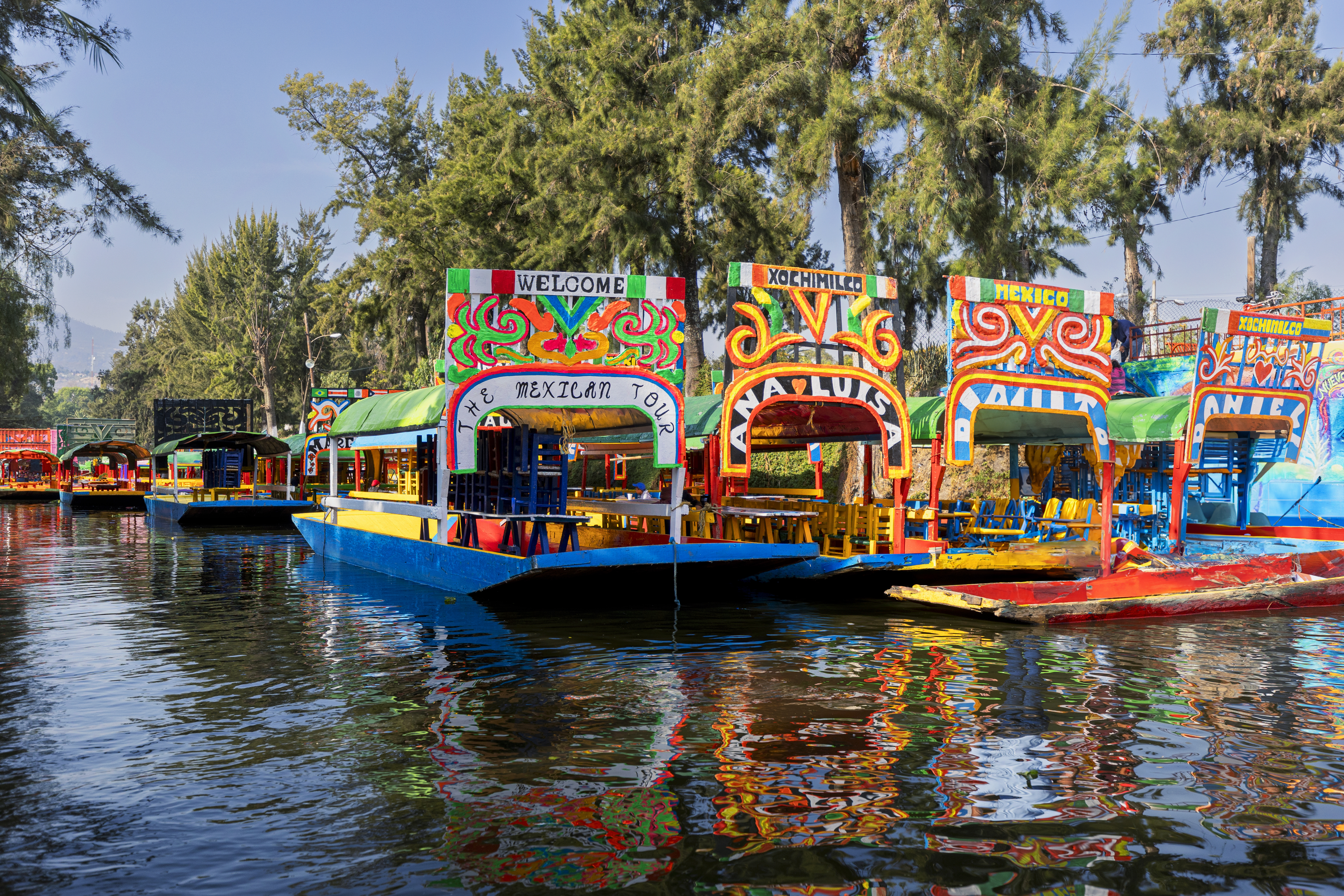 Vibrant Xochimilco trajineras on canals in Mexico City.