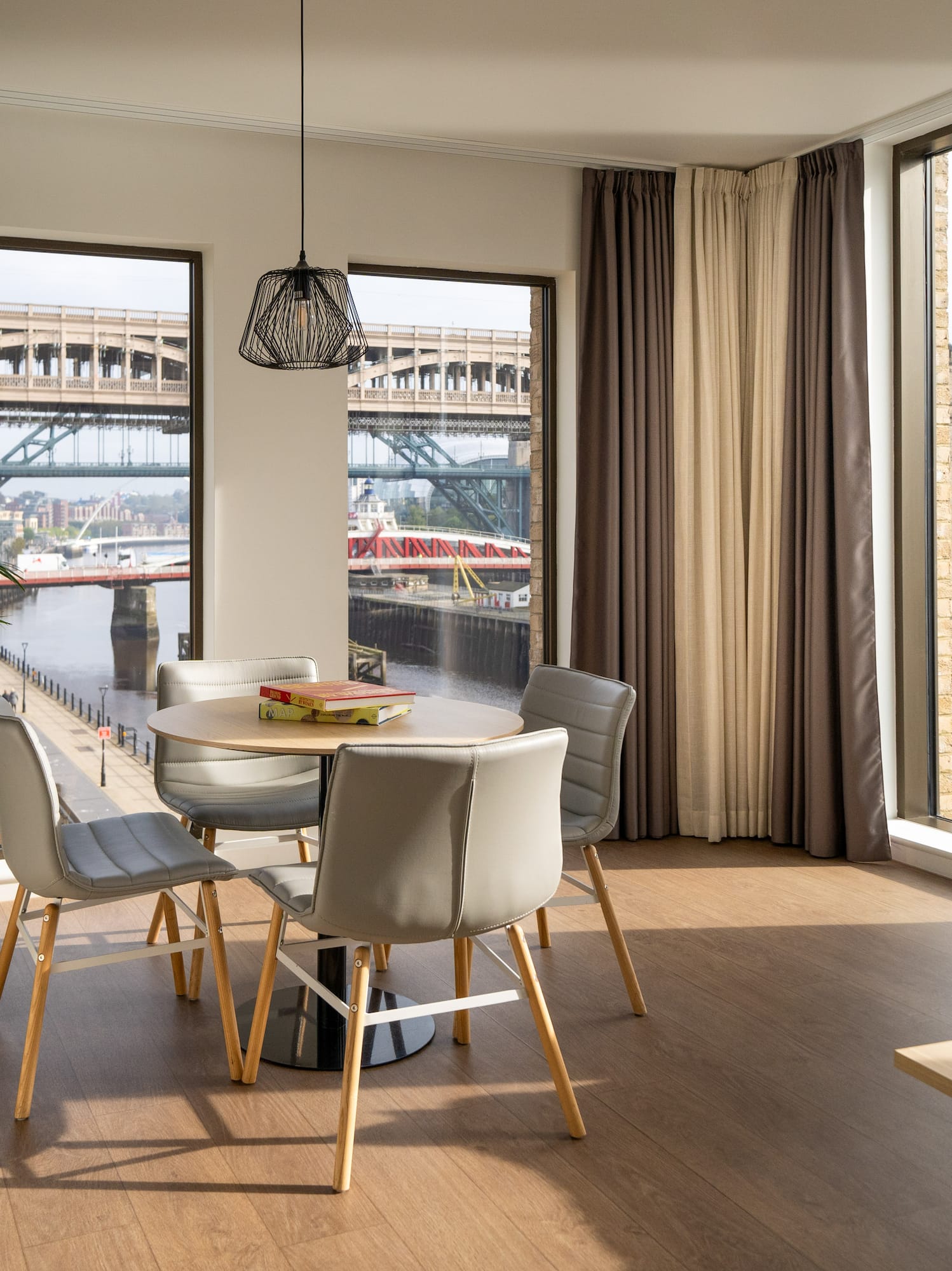 Modern apartment living & dining area overlooking Newcastle's Tyne bridges.