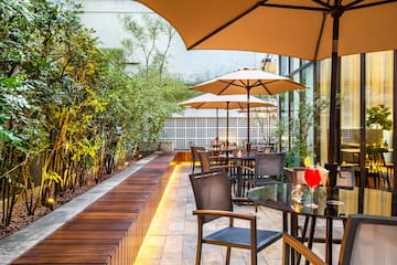 a patio with tables and umbrellas