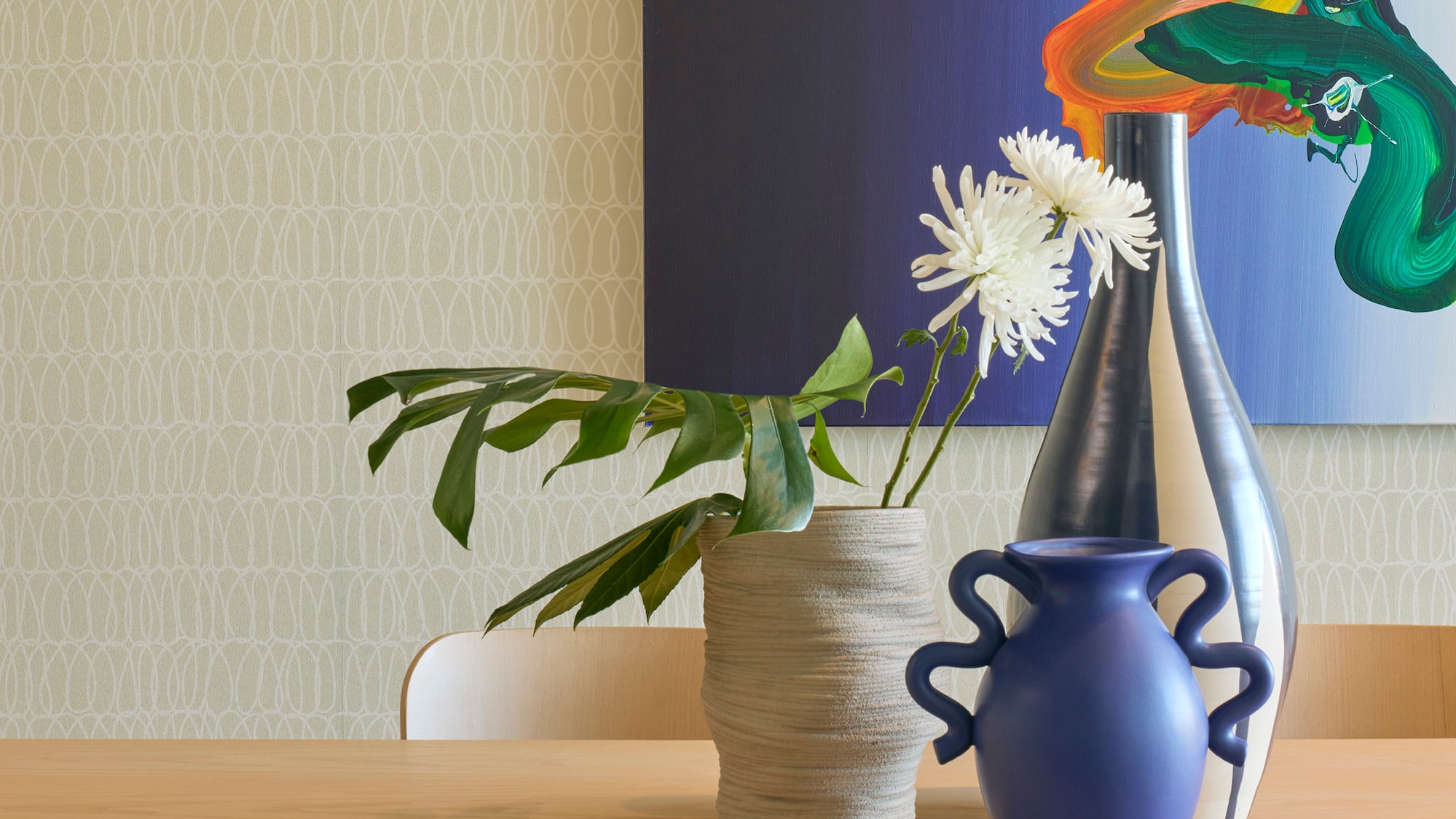 a table with chairs and vases on it