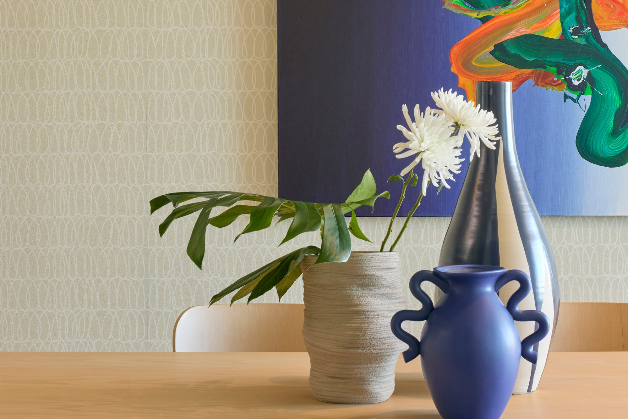 a table with chairs and vases on it