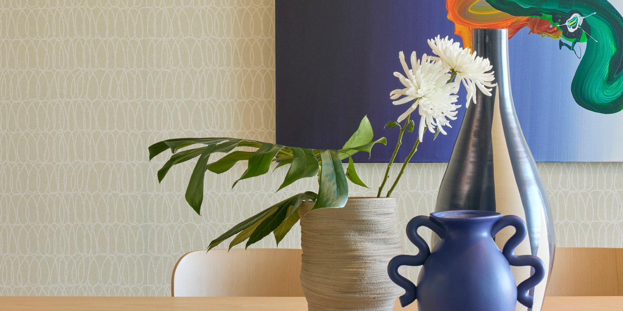 a table with chairs and vases on it