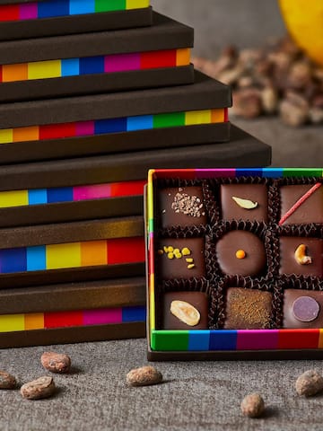 a box of chocolates next to a stack of boxes