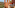 Terracotta balcony with outdoor seating, scenic sea view, and coastal resort.