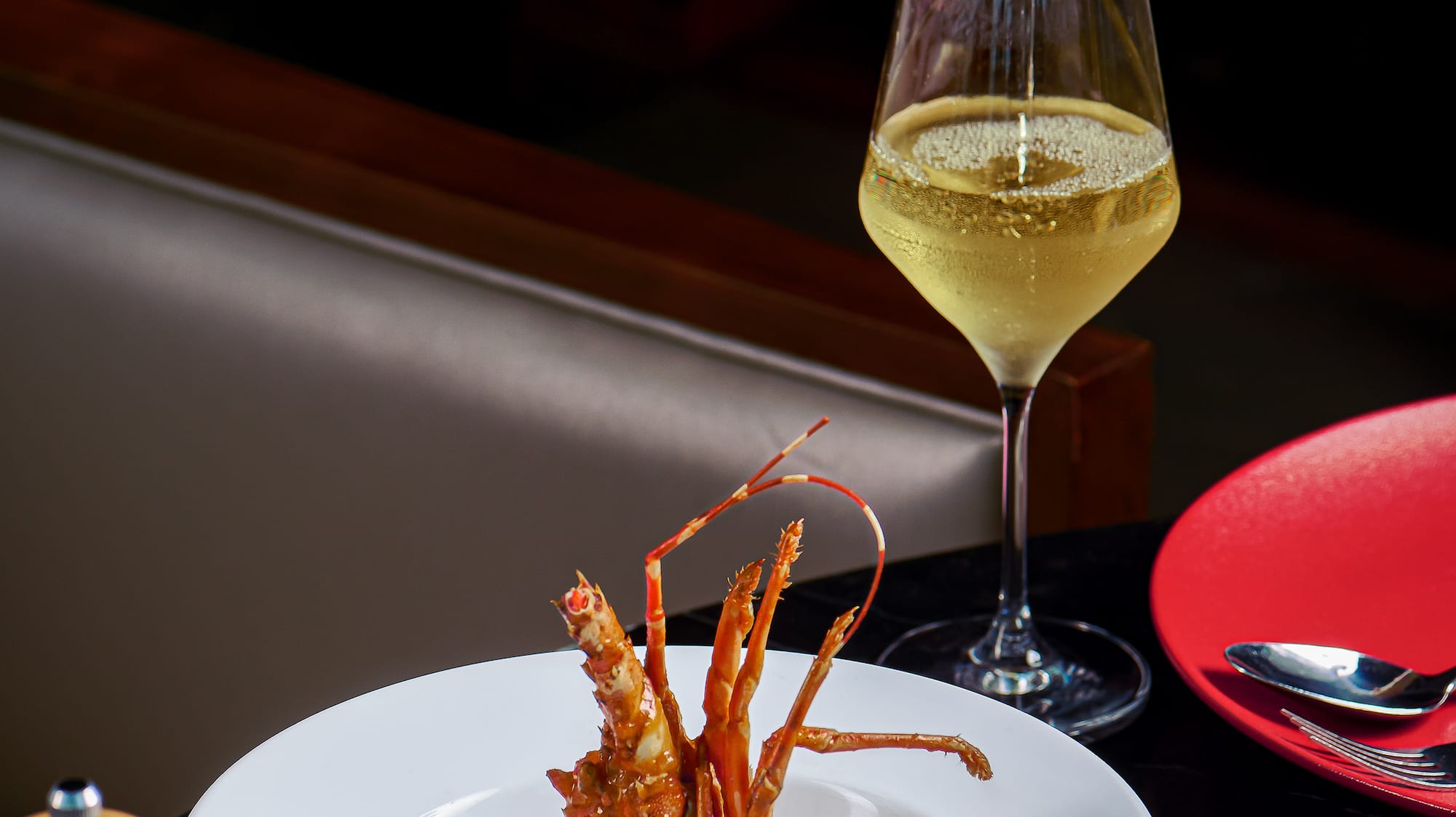 a bowl of food and a glass of wine