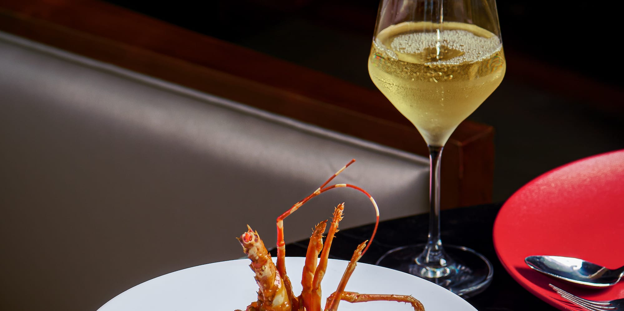 a bowl of food and a glass of wine