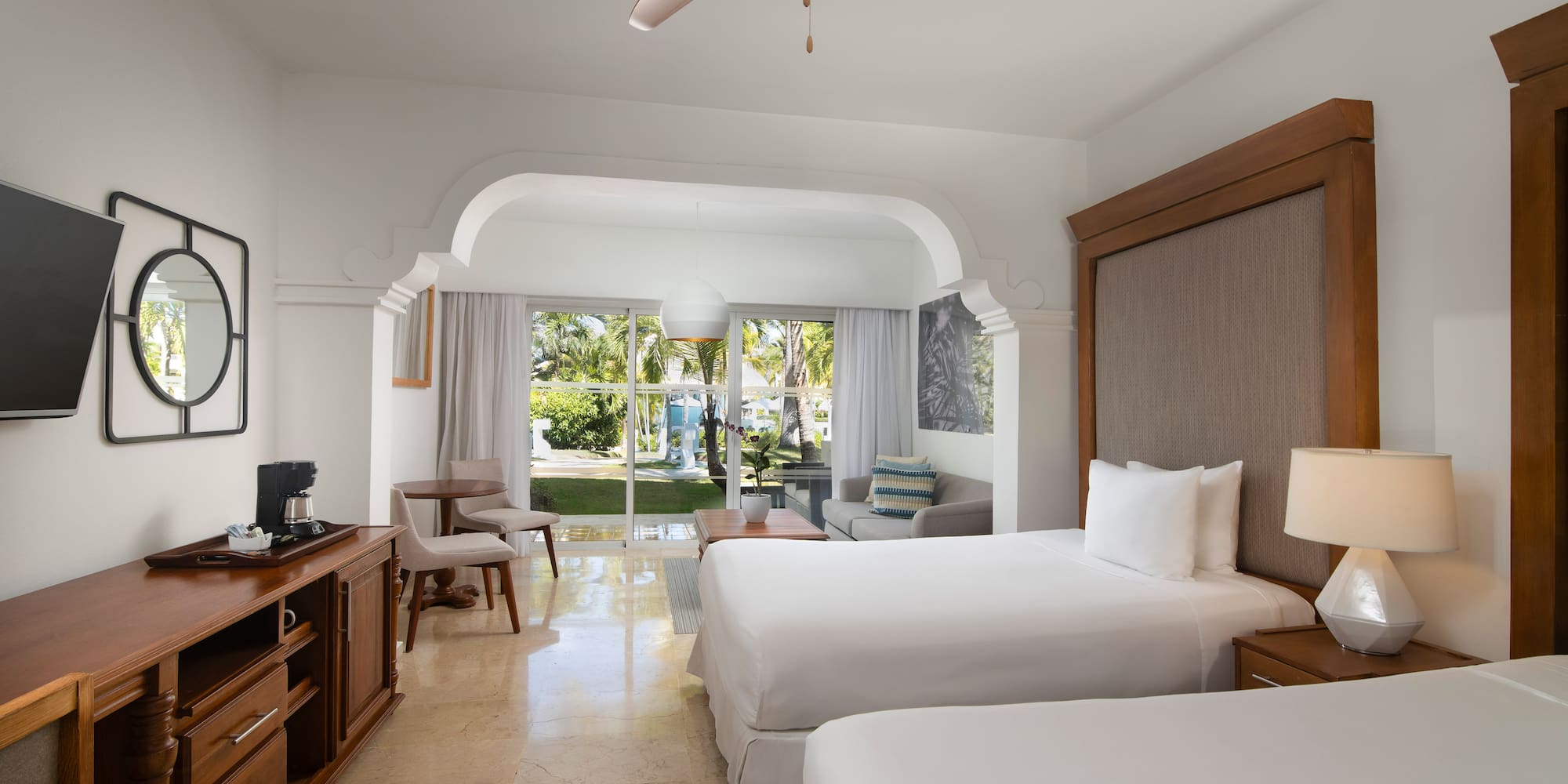 a room with two beds and a television