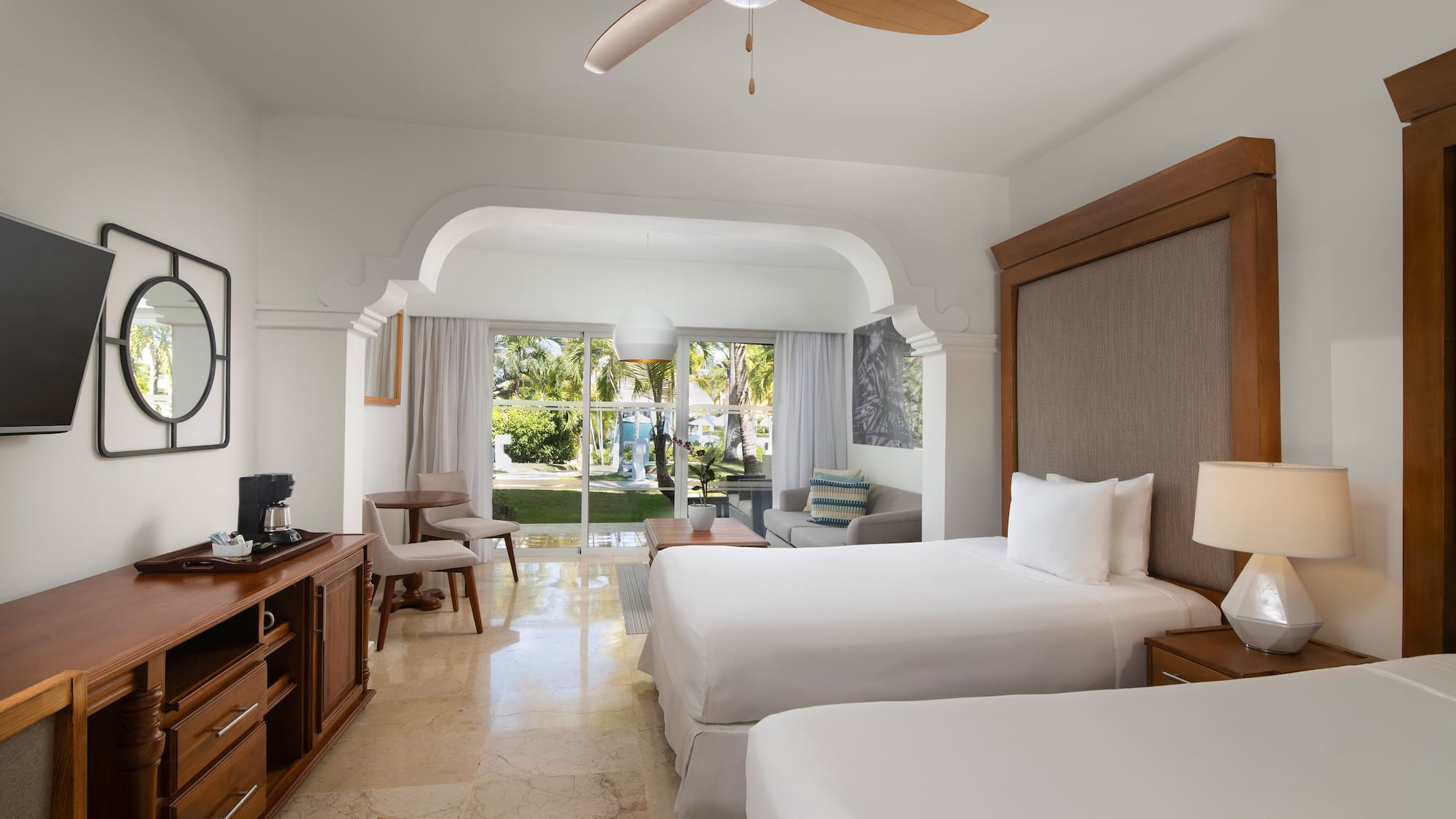 a room with two beds and a television