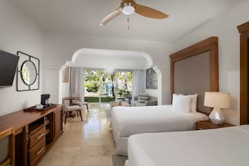 a room with two beds and a television