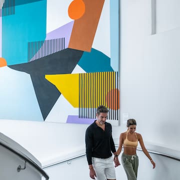a man and woman walking down a staircase