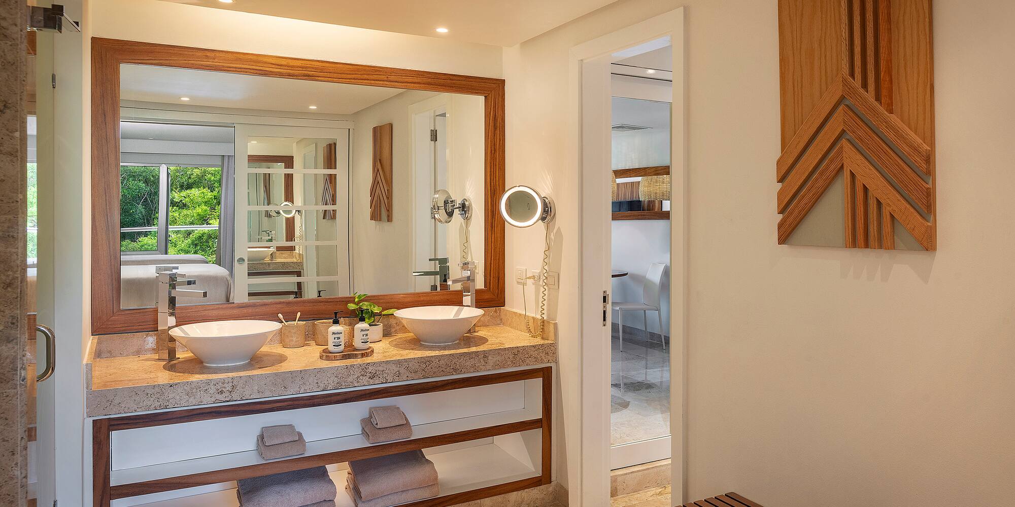 a bathroom with a large mirror and sinks