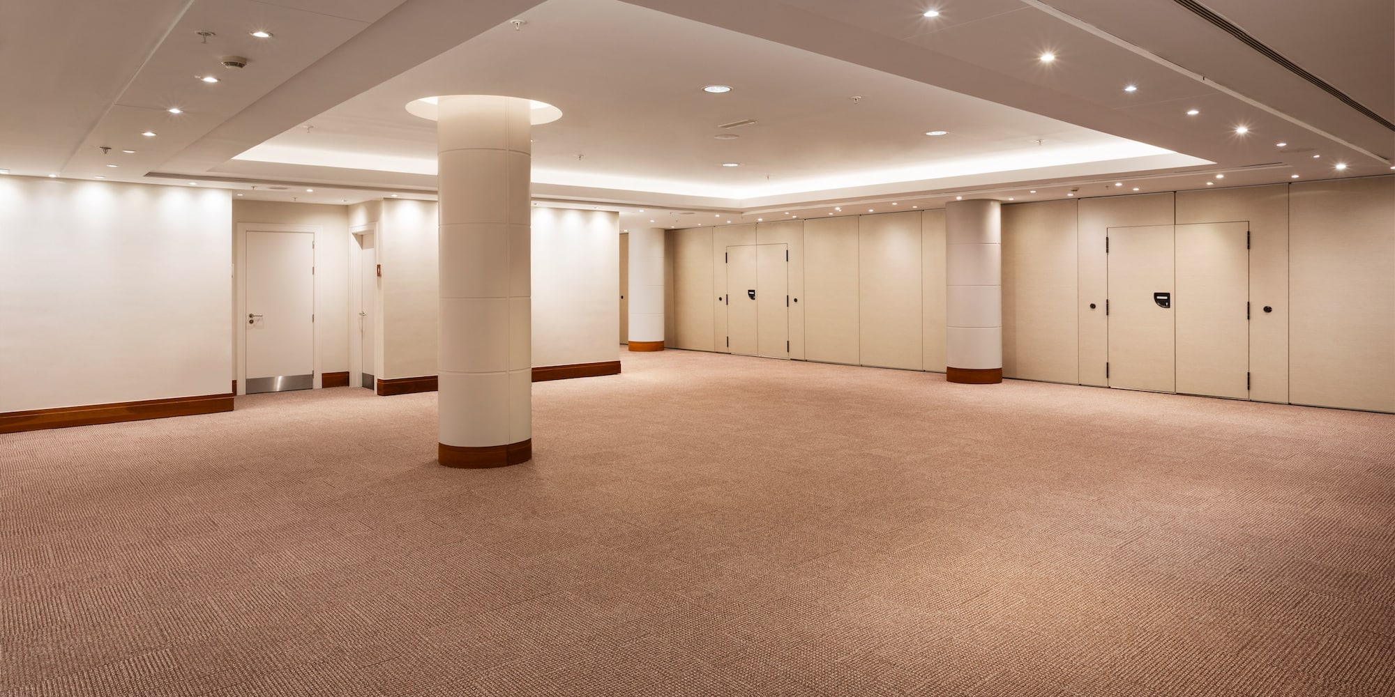 a room with doors and a column