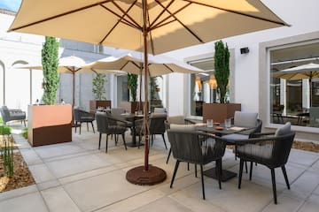 a patio with chairs and umbrellas