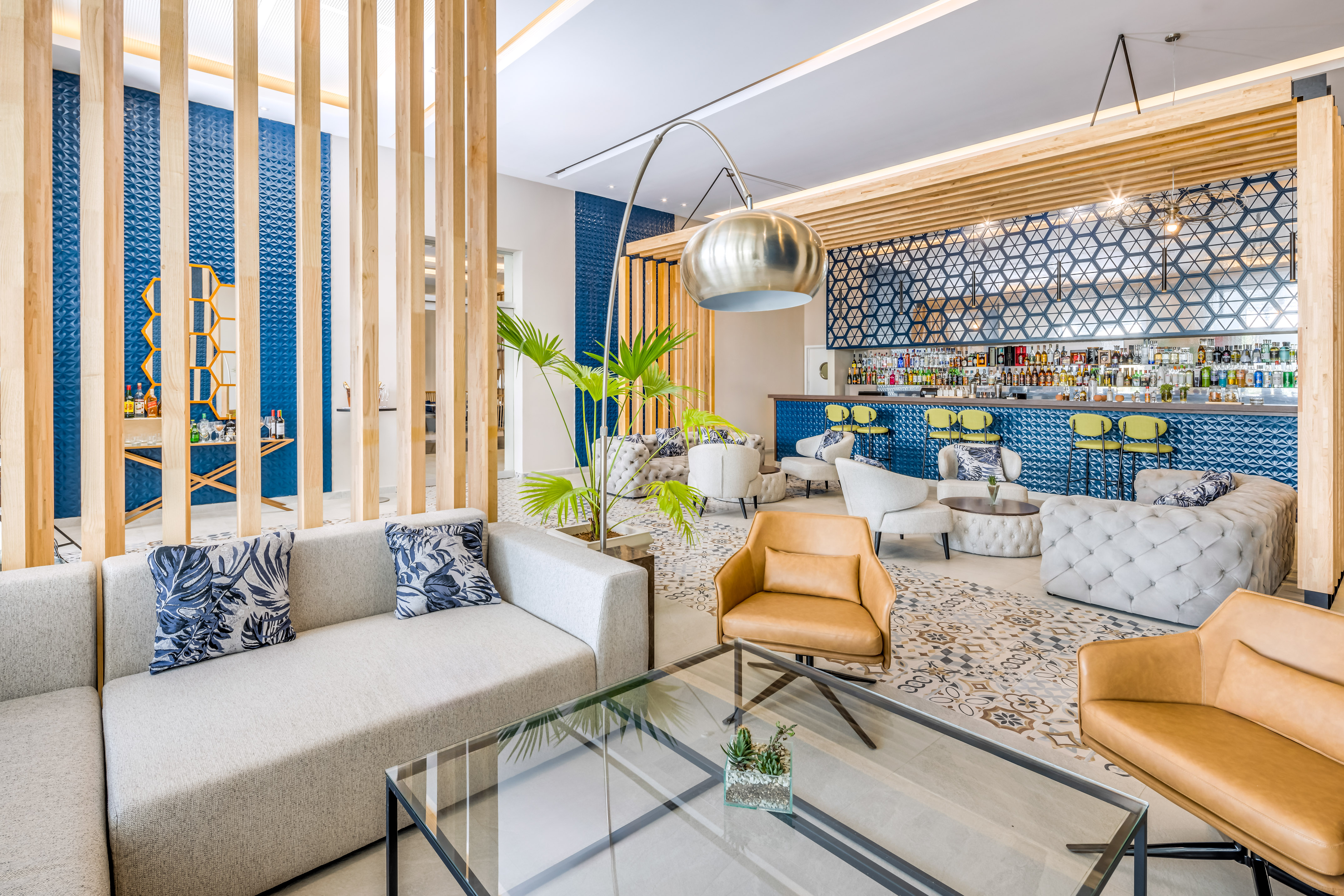 a room with a bar and lounge area