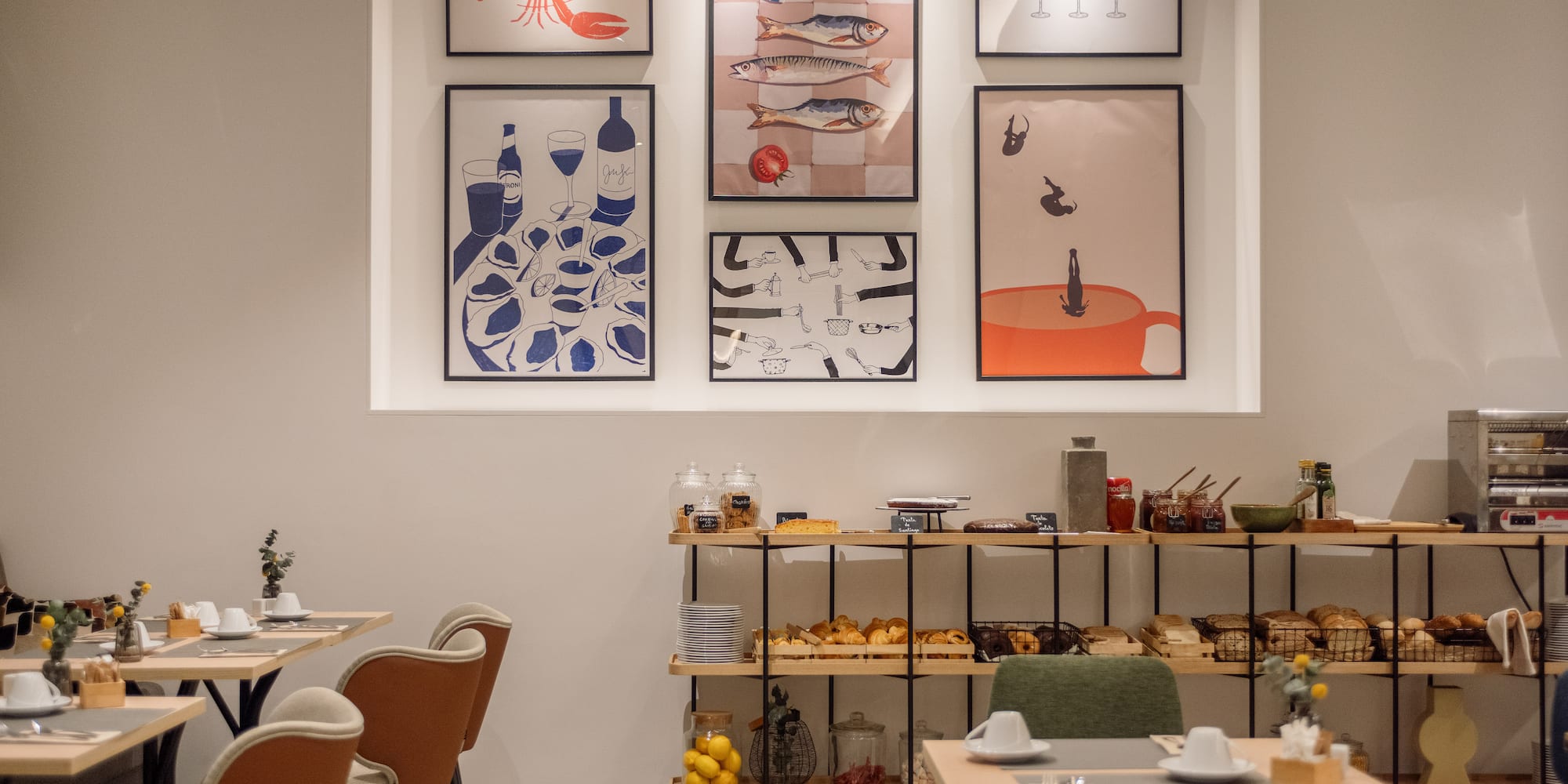 a room with a table and chairs and art on the wall