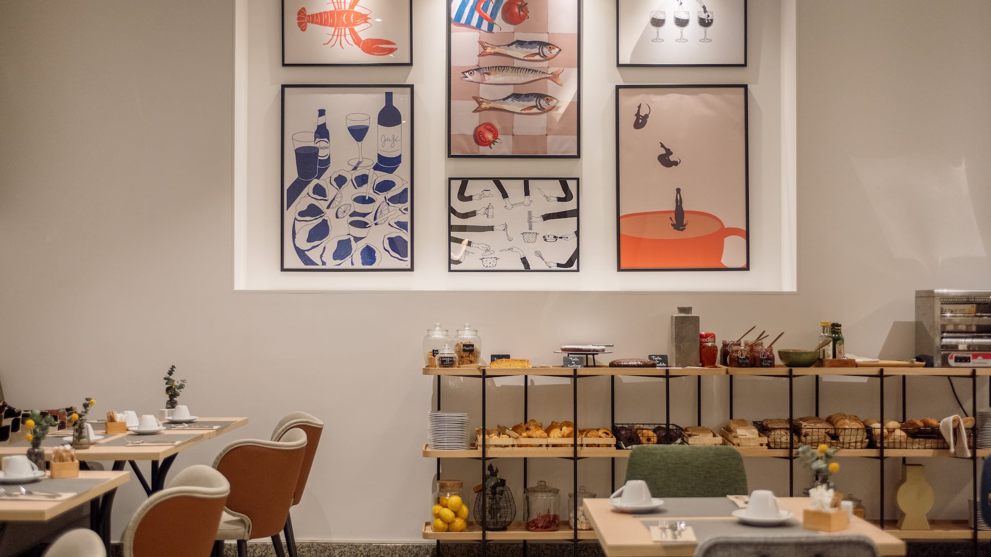 a room with a table and chairs and art on the wall