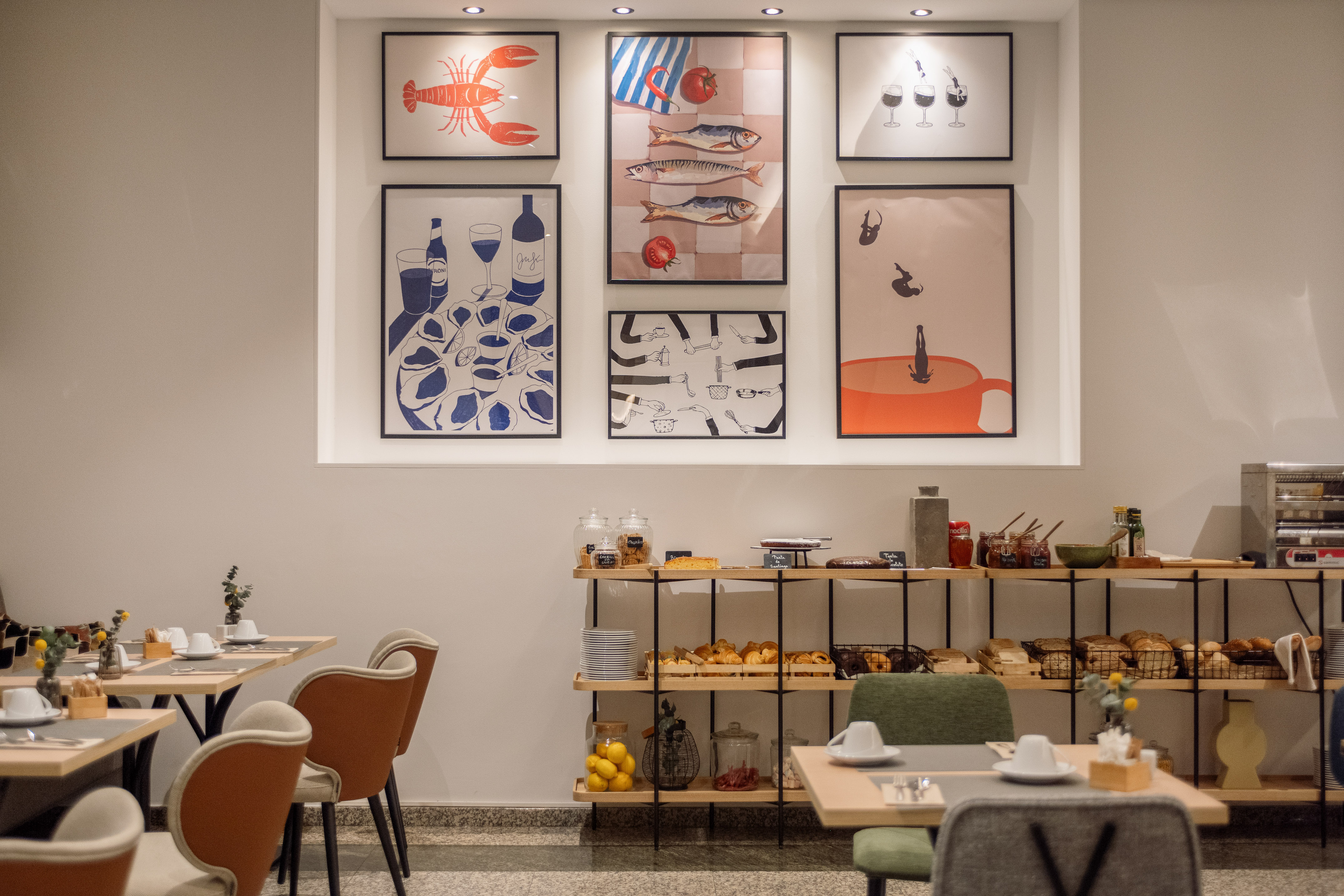 a room with a table and chairs and art on the wall