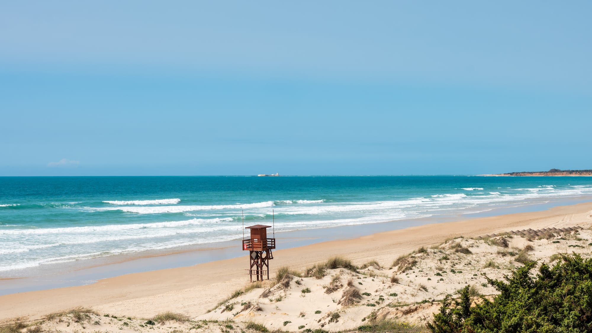 a beach with a lifeguard tower