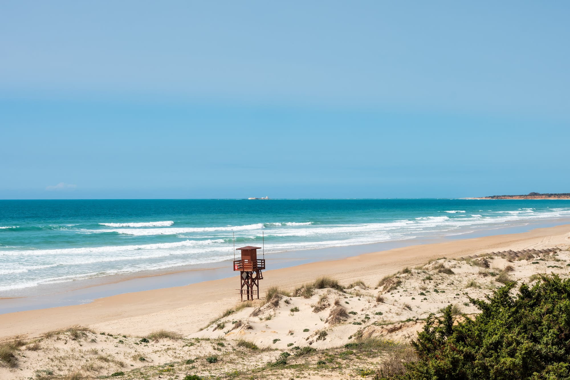 a beach with a lifeguard tower