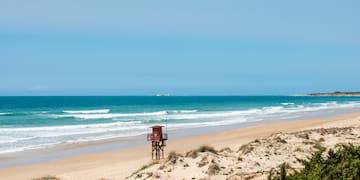 a beach with a lifeguard tower