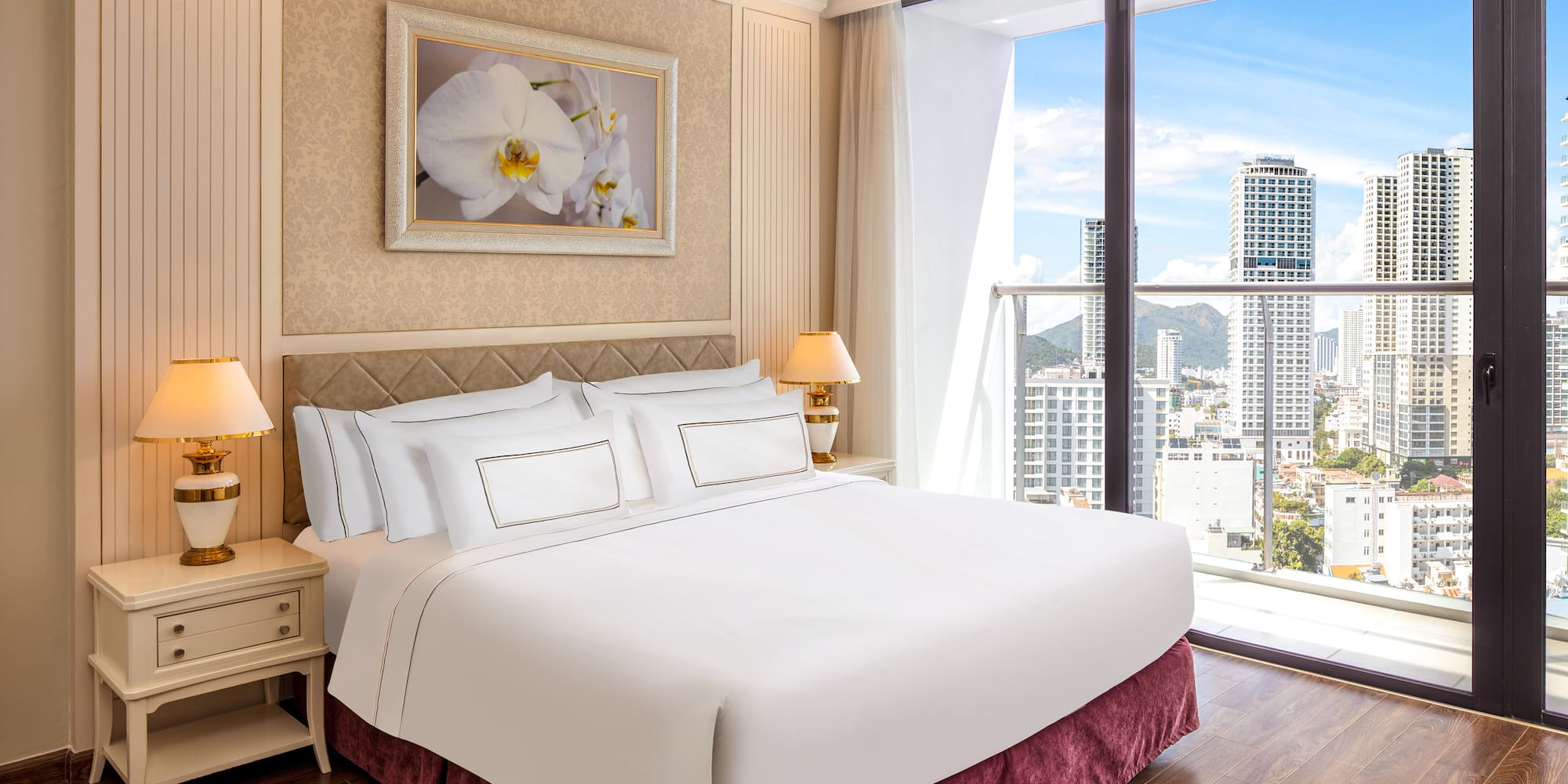 a bedroom with a large window and a large picture of a city