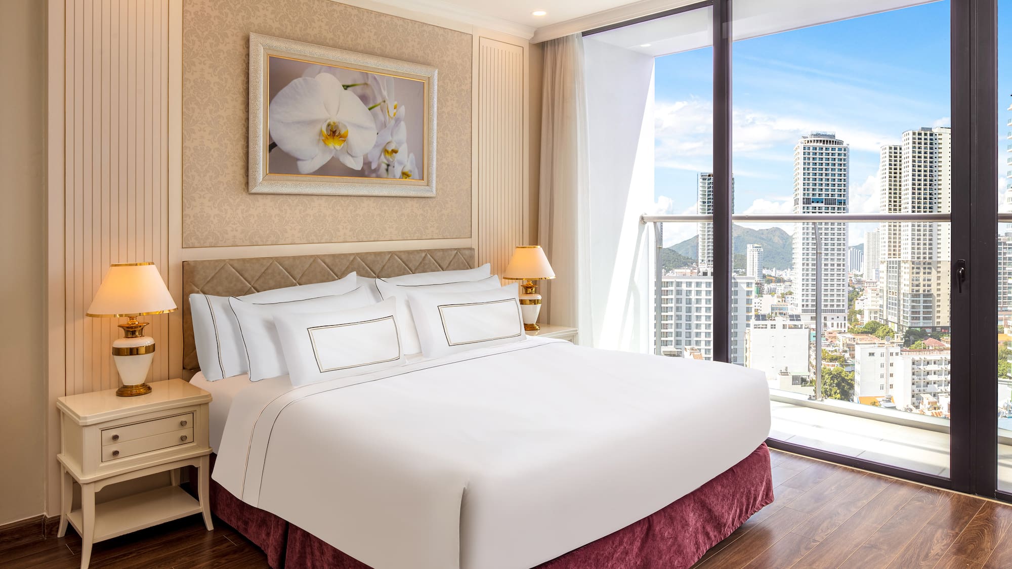 a bedroom with a large window and a large picture of a city