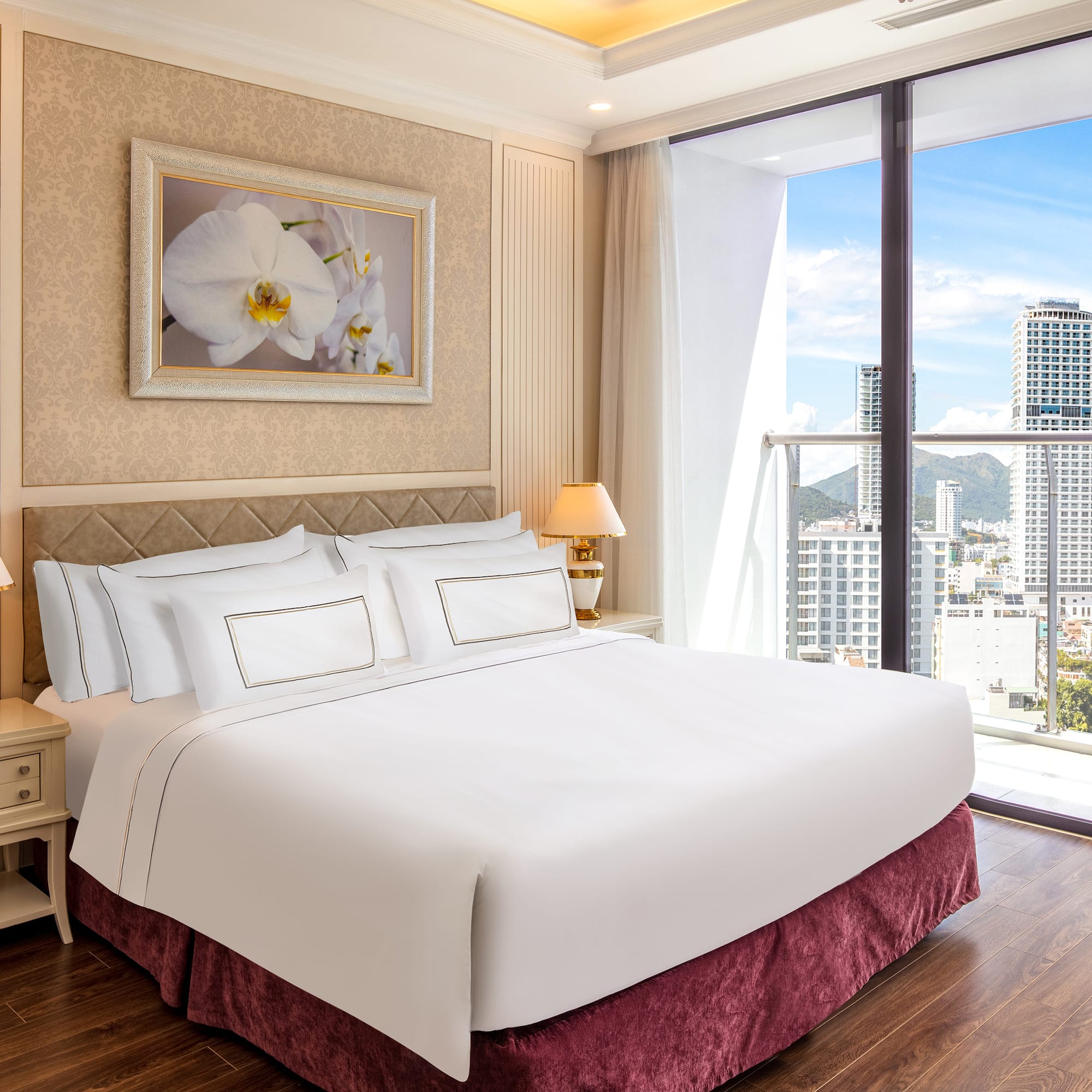 a bedroom with a large window and a large picture of a city