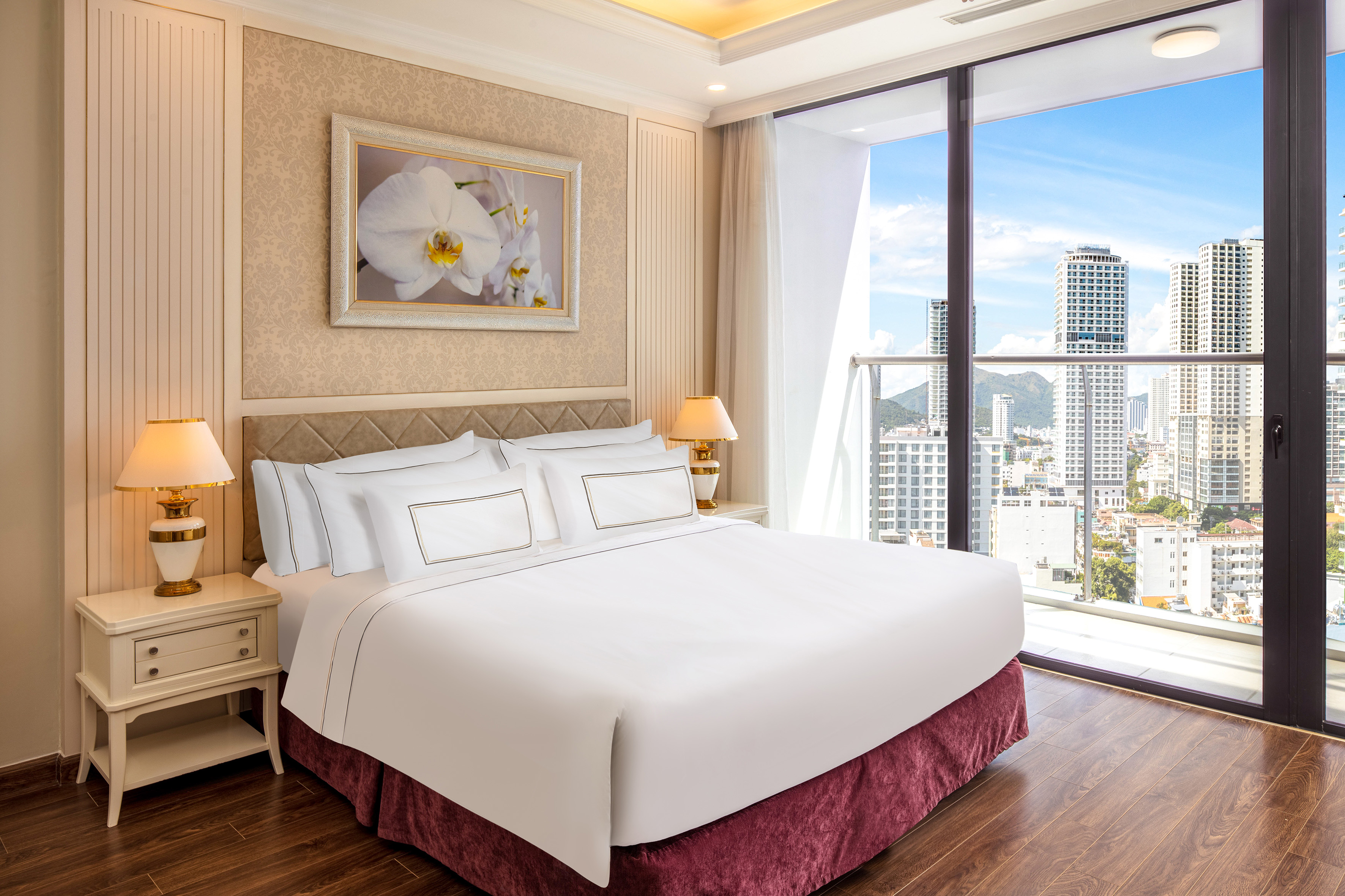 a bedroom with a large window and a large picture of a city