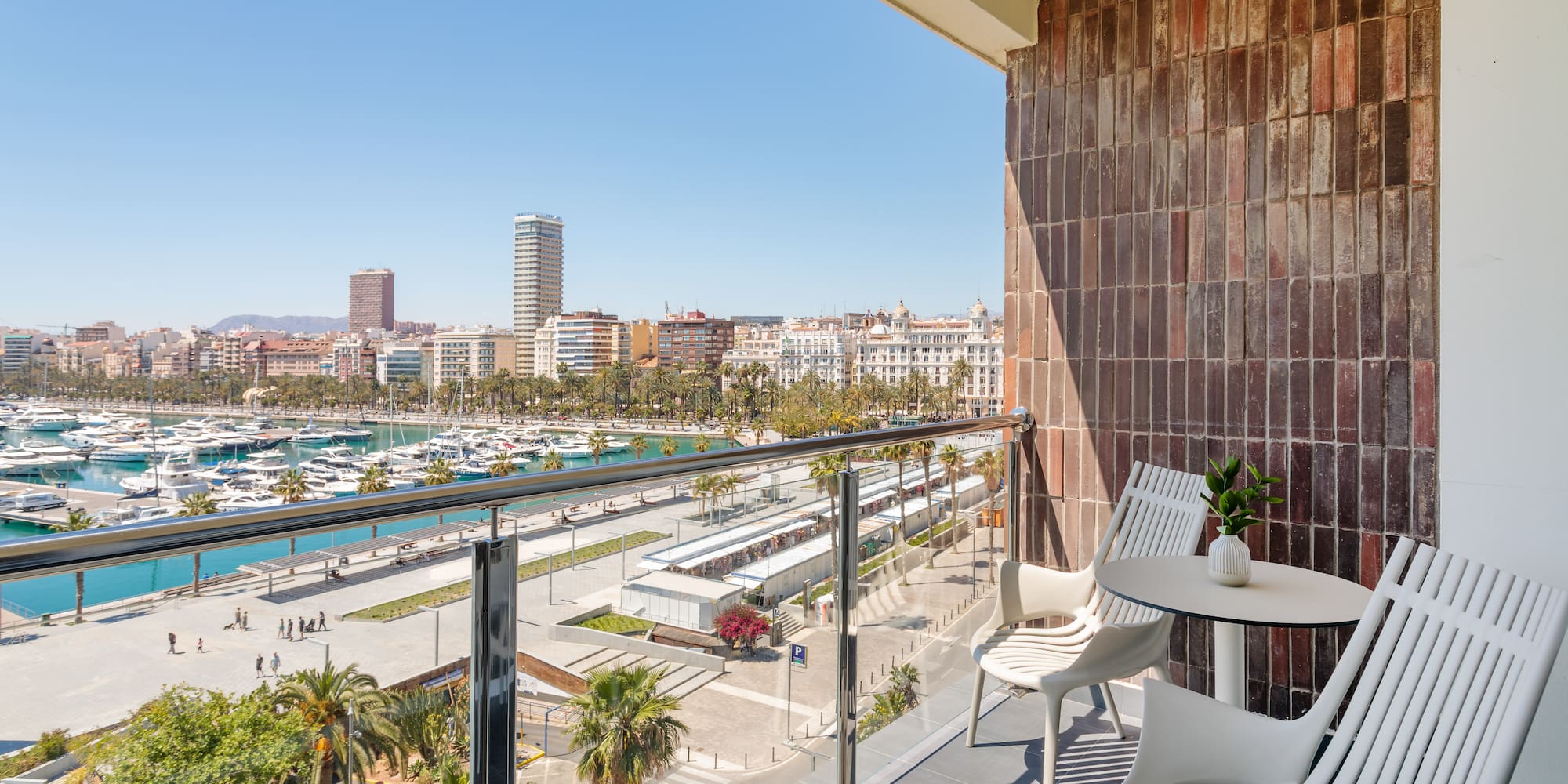a balcony with a view of a city and boats and a city