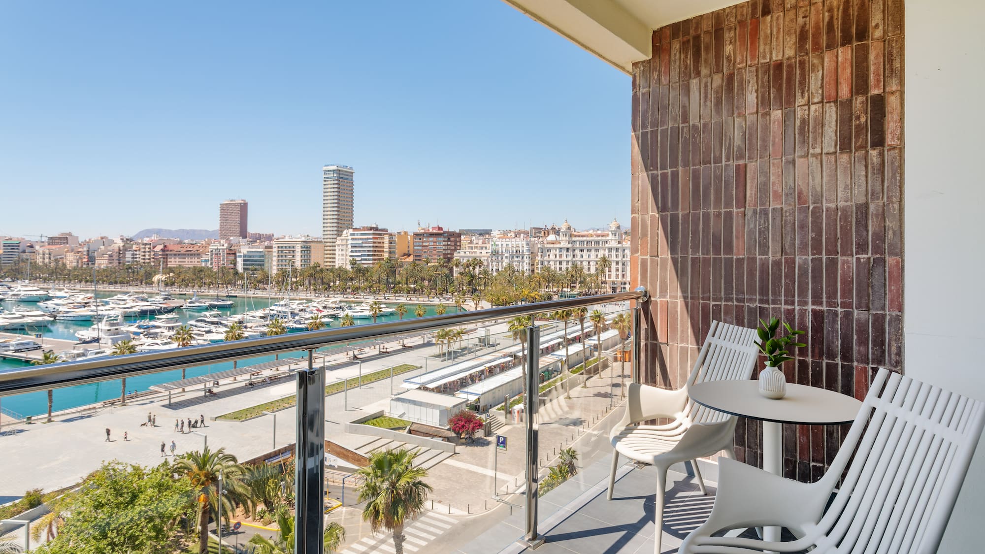 a balcony with a view of a city and boats and a city