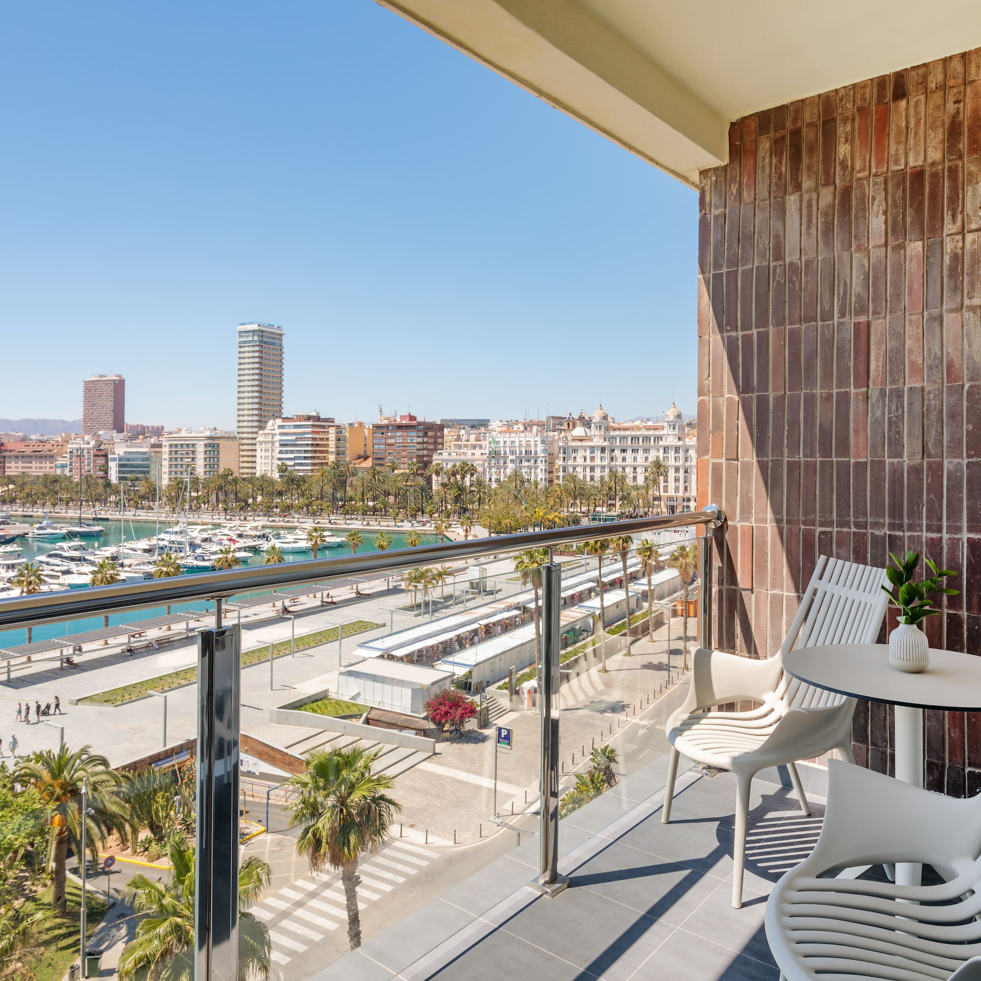 a balcony with a view of a city and boats and a city
