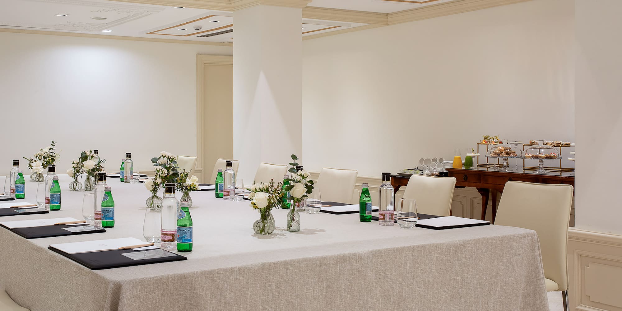 a large room with white tables and chairs