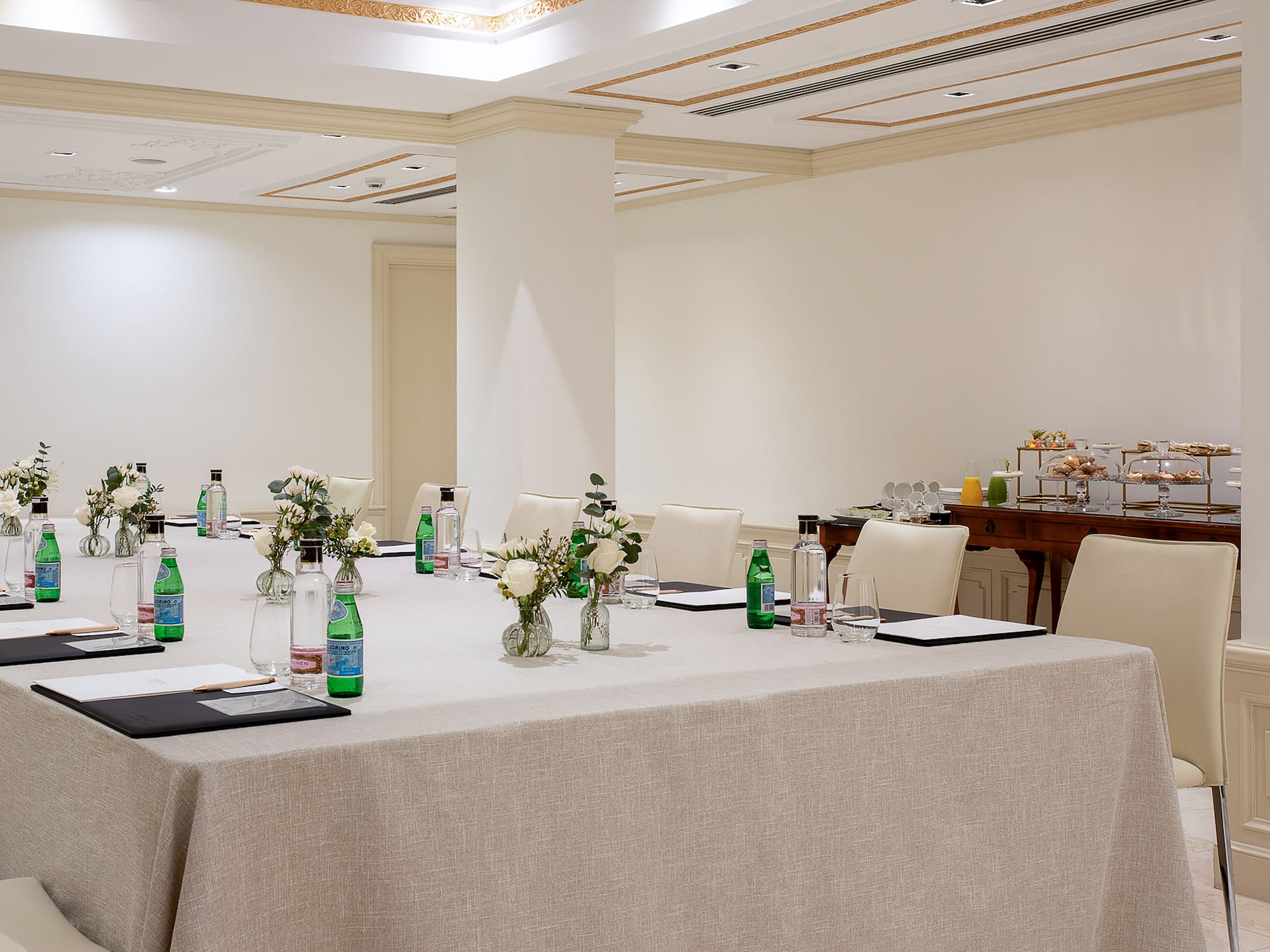 a large room with white tables and chairs