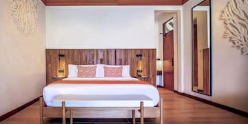 a bed with a wood headboard in a room
